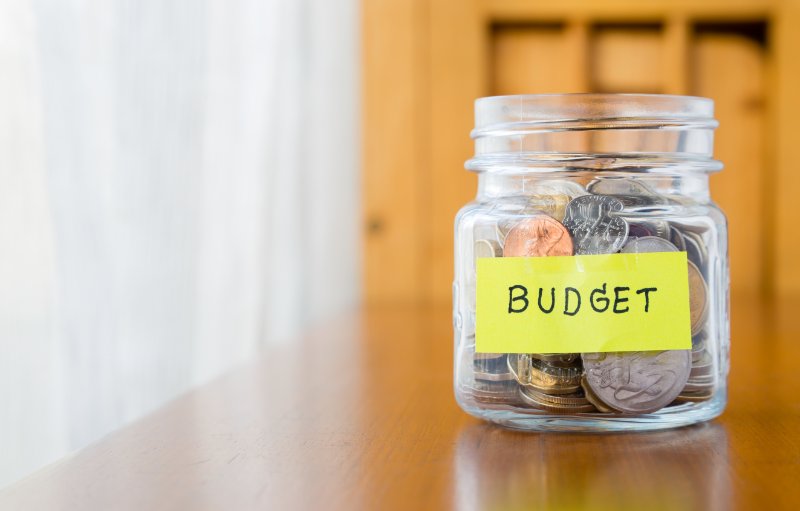 Glass jar with coins and budget label