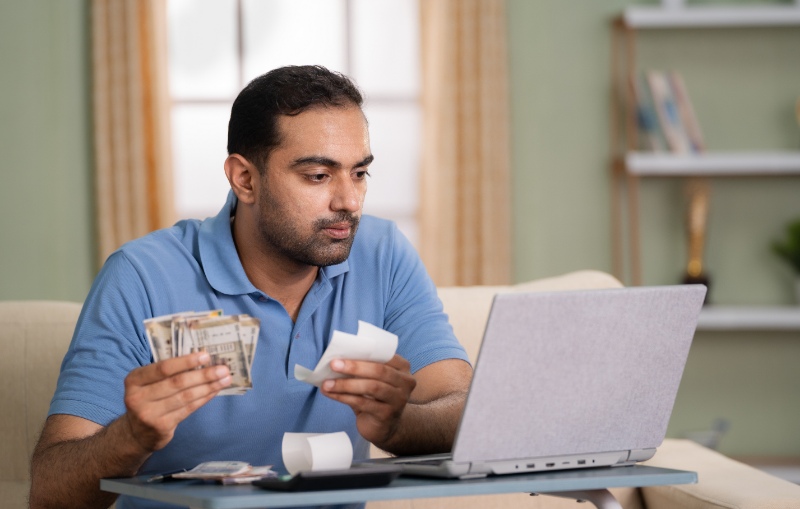 Man holding money and receipts