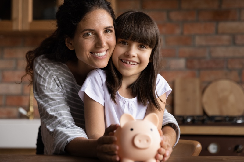 Mother and child with a piggy bank