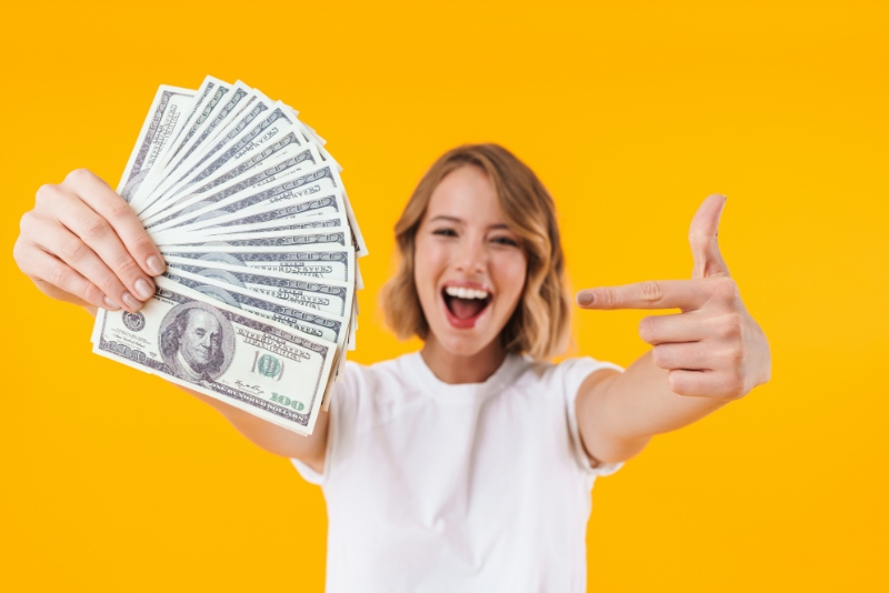 Woman holding a bunch of cash