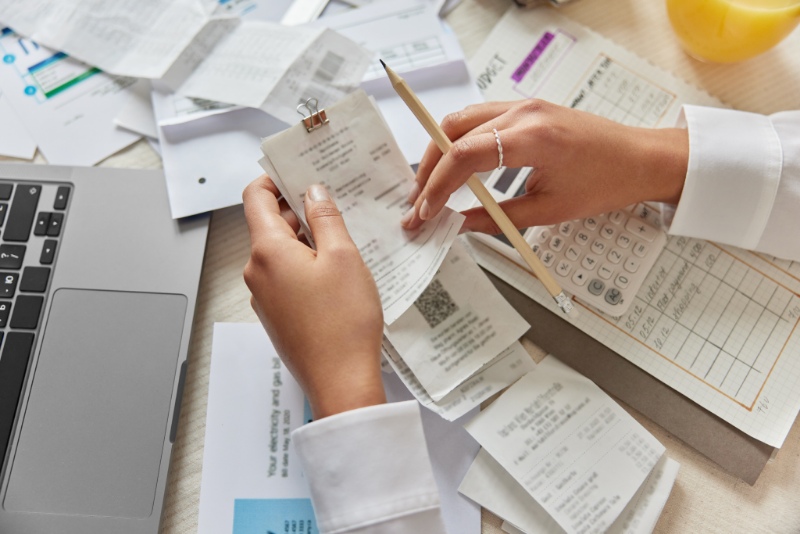 Woman budgeting holding a set of receipts