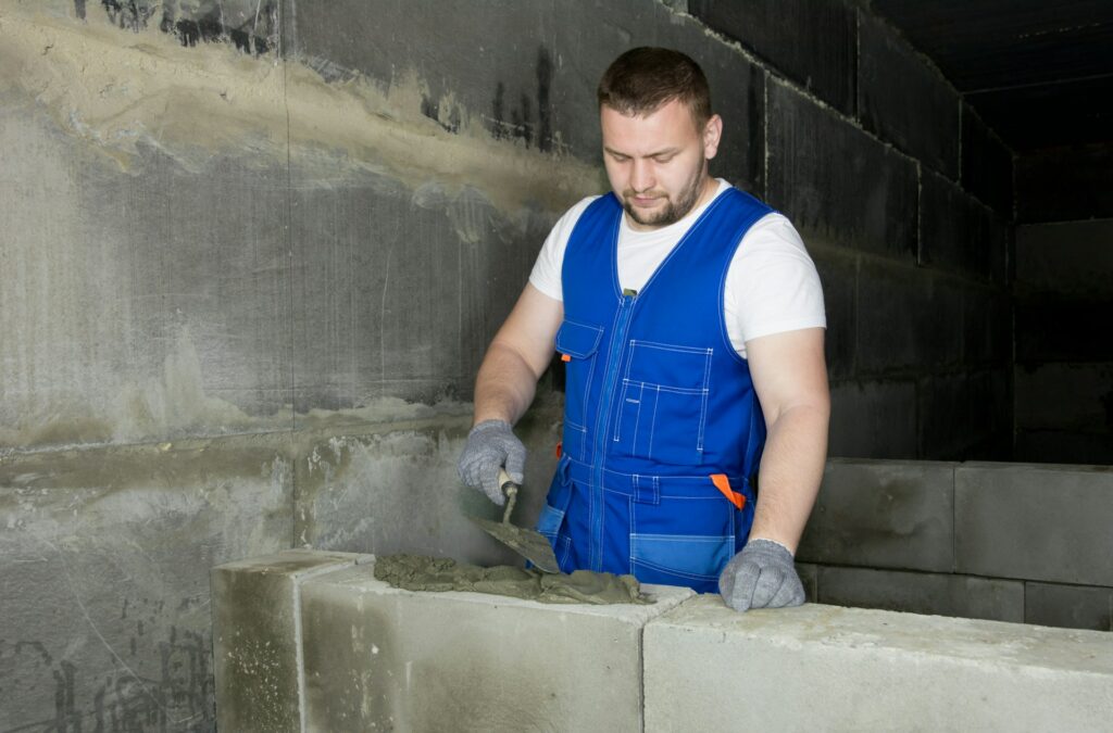 Cement Mason working on bricks