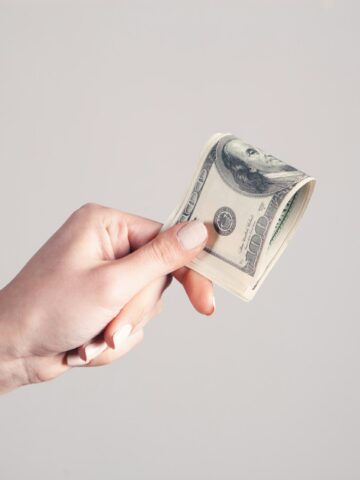 Hand holding a dollar bill