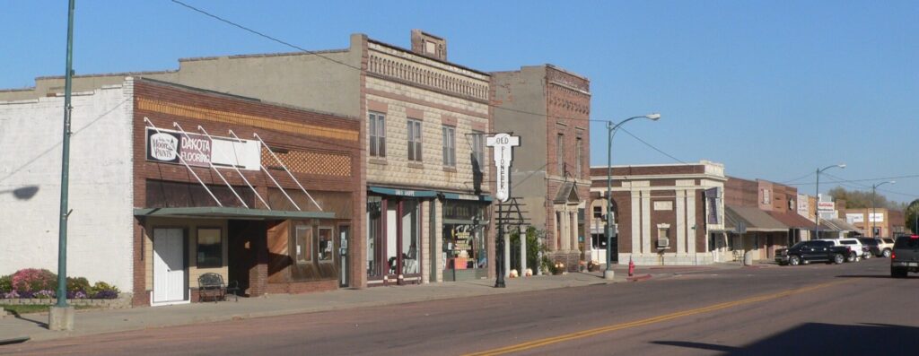 Street scene in Gregory County, South Dakota, featuring several buildings lining the road.