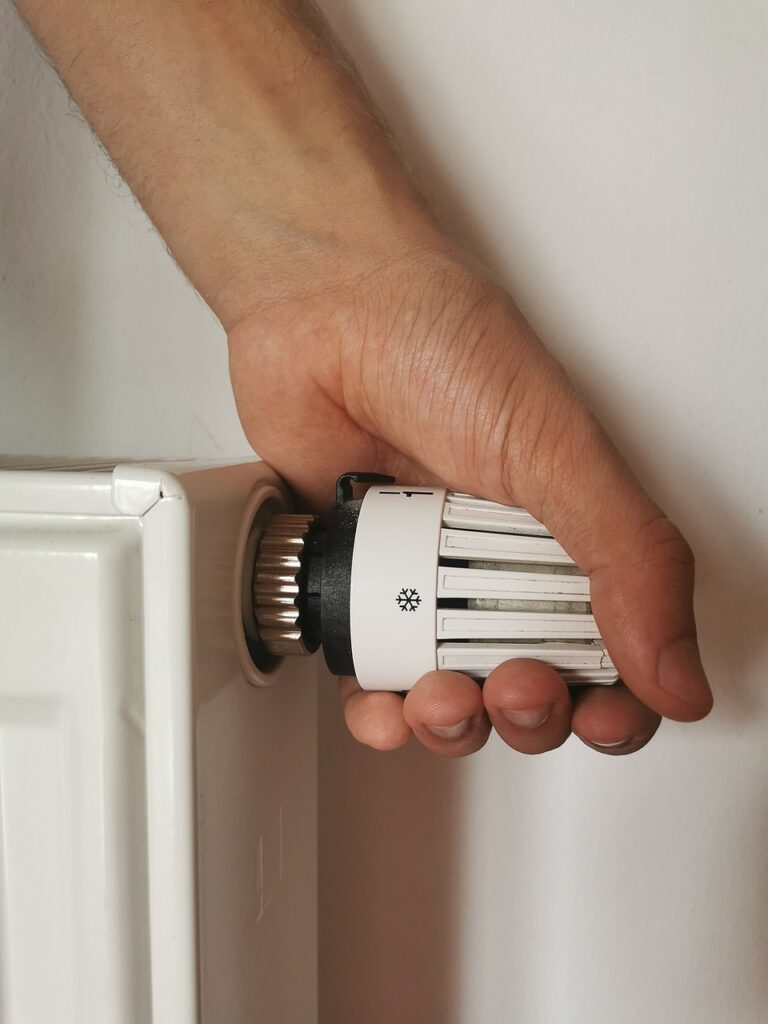 Hands checking heating control