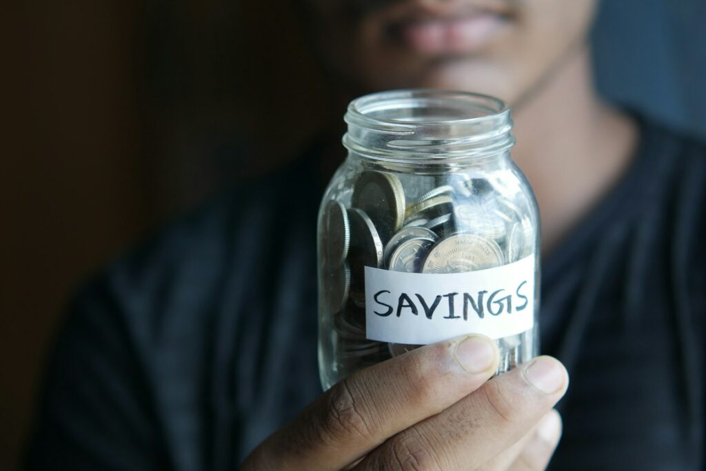 Man holding a money savings jar