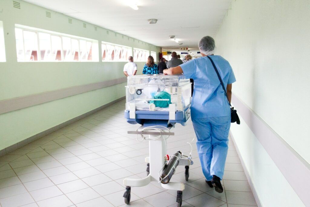 Nurse in blue scrub suit in an hospital hallway