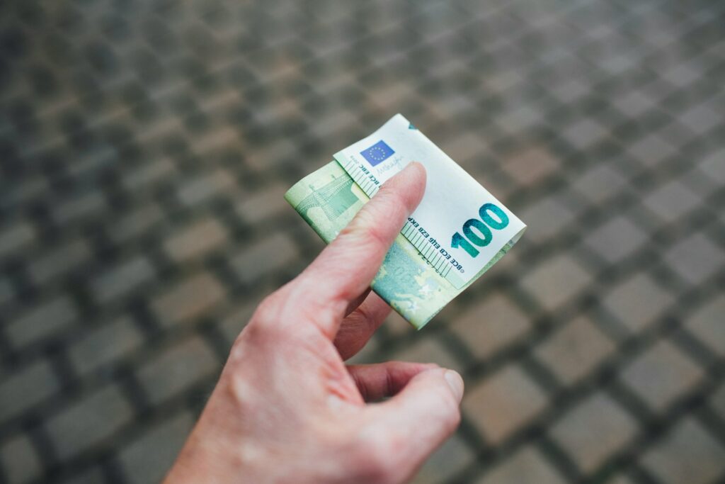 Man holding and paying in euros in their hand 