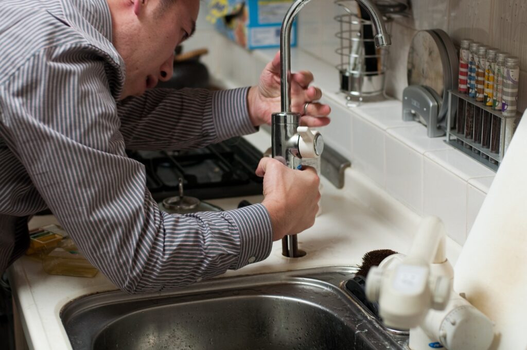 Plumber repairing the sink