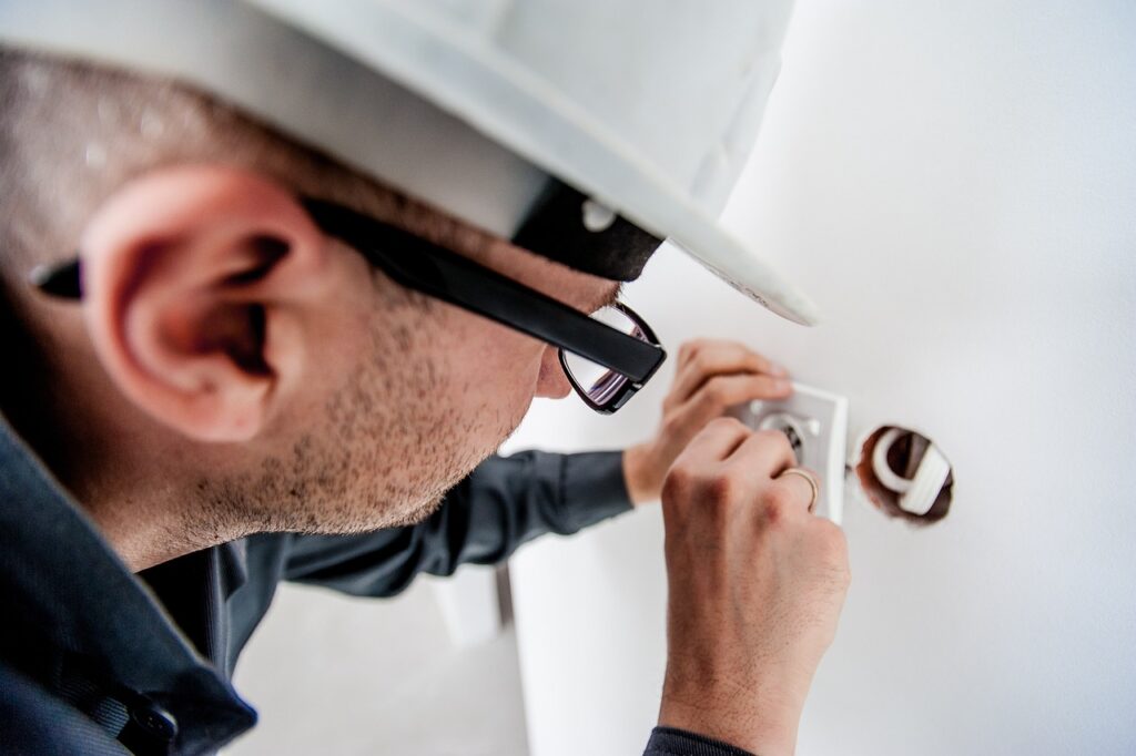 Man repairing an electric outlet