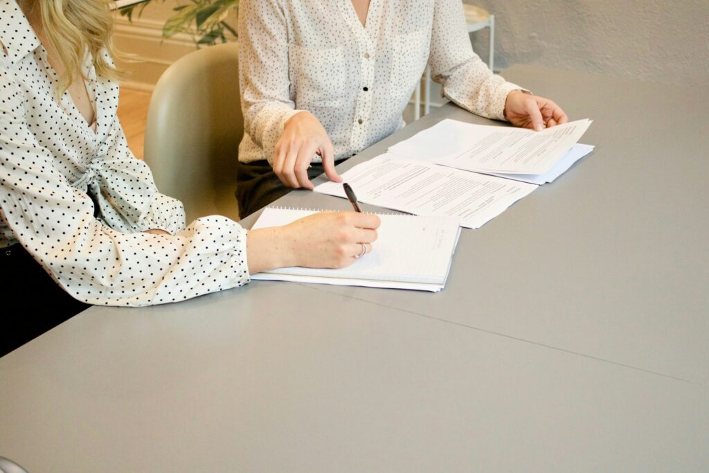Woman signing documents and taking notes