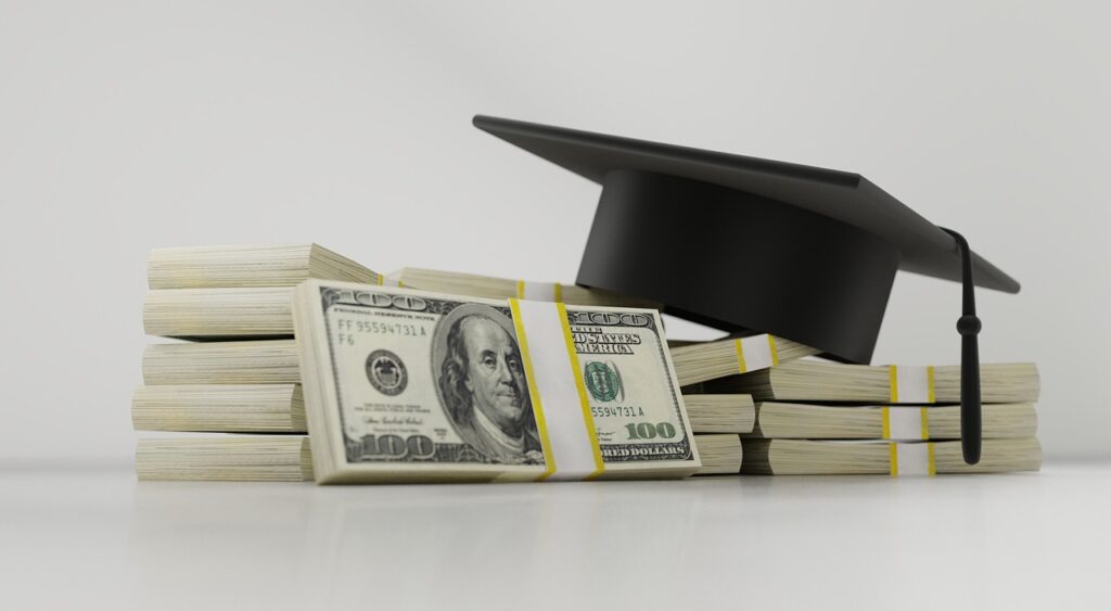 Stock of dollar bills and a graduation cap