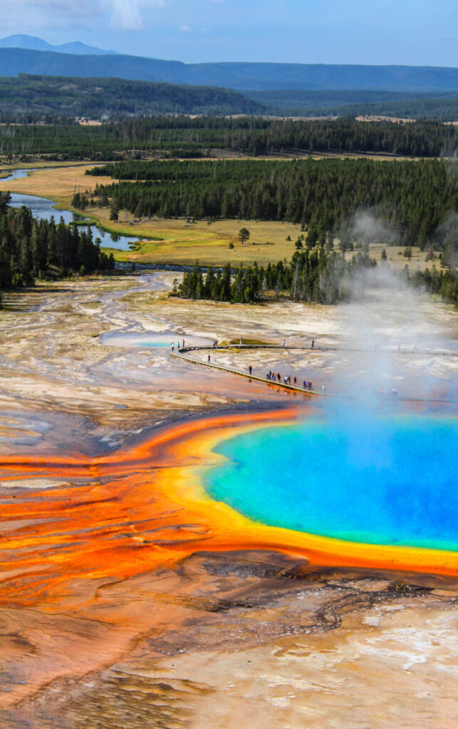 Grand Prismatic Spring in Yellowstone National Park, featuring bright blue water surrounded by orange and yellow mineral deposits